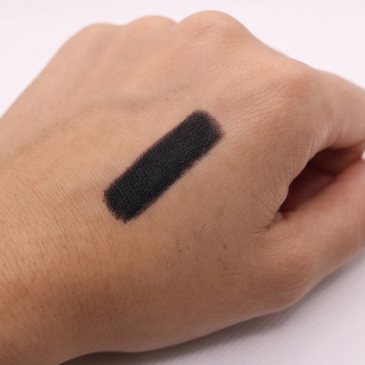 Black lip liner swatch on a person's wrist
