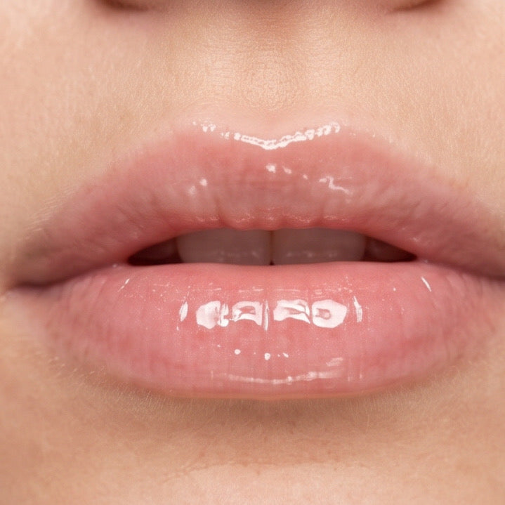 Close-up of glossy lips  after applying clear lip gloss 