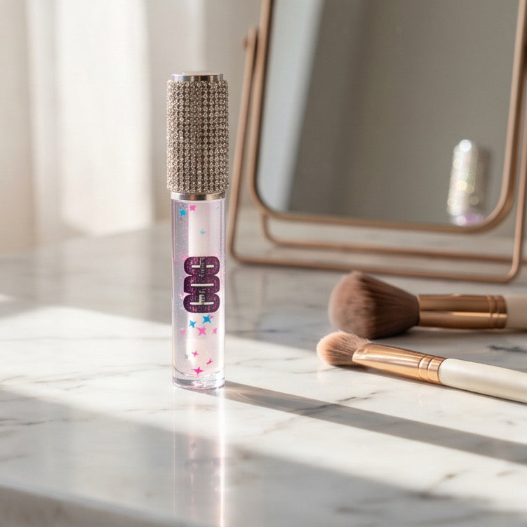 Makeup product with decorative cap on a marble surface with brushes and mirror in the background