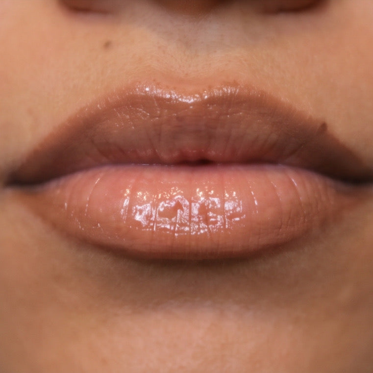 Close-up of a person's lips  applying light brown lip liner by Amourlyah Beauty